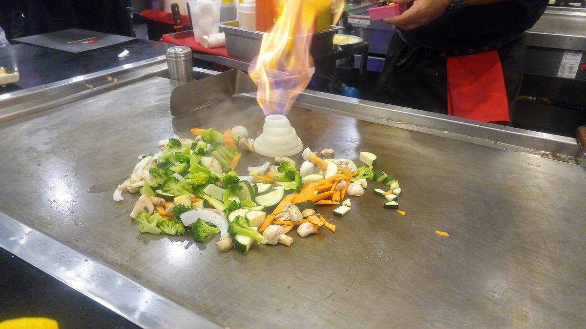 A flaming volcano built from onions on the teppanyaki grill at Sapporo Japanese Steakhouse & Sushi.