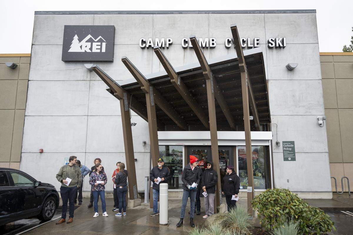 Picketers in support of REI Union workers hand out fliers outside of an REI Co-op location on Friday, May 15, 2026, in Tacoma, Wash. The fliers share information about the union's 10-day boycott of the REI Co-op's Anniversary Sale.