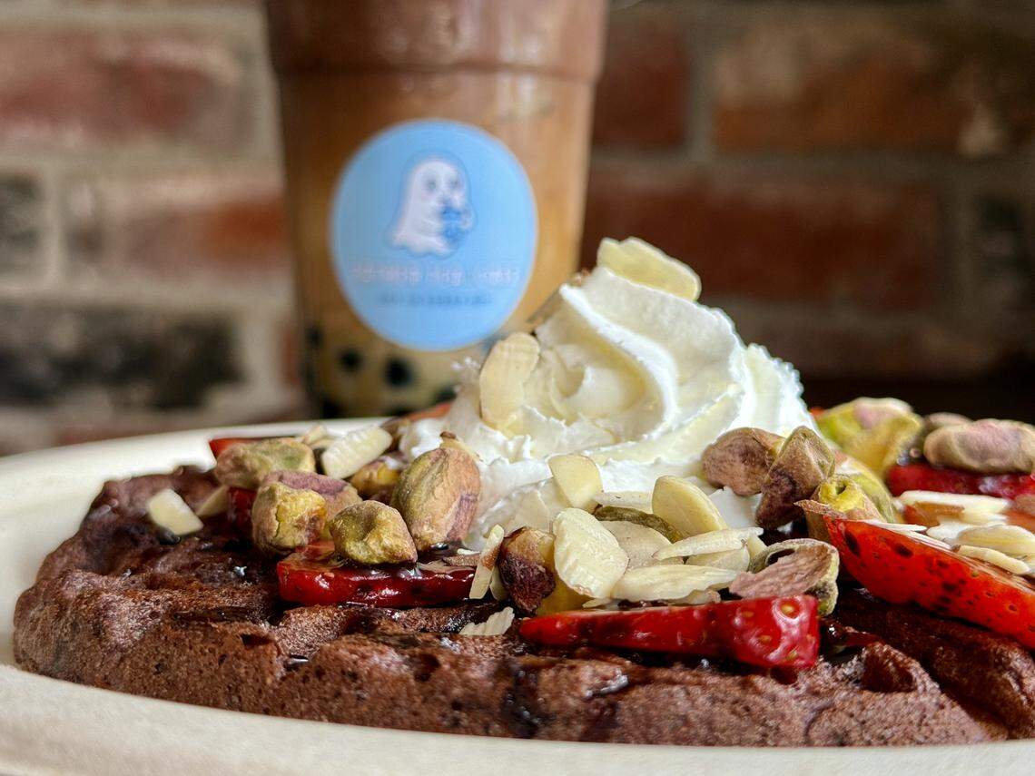 Eather Tea & Cafe opened at 1127 Broadway in August 2025 with Vietnamese coffee, fruit and milk teas, matcha and dessert waffles. Pictured here is the pandan-coconut coffee with boba and the chocolate waffle with strawberries and nuts.