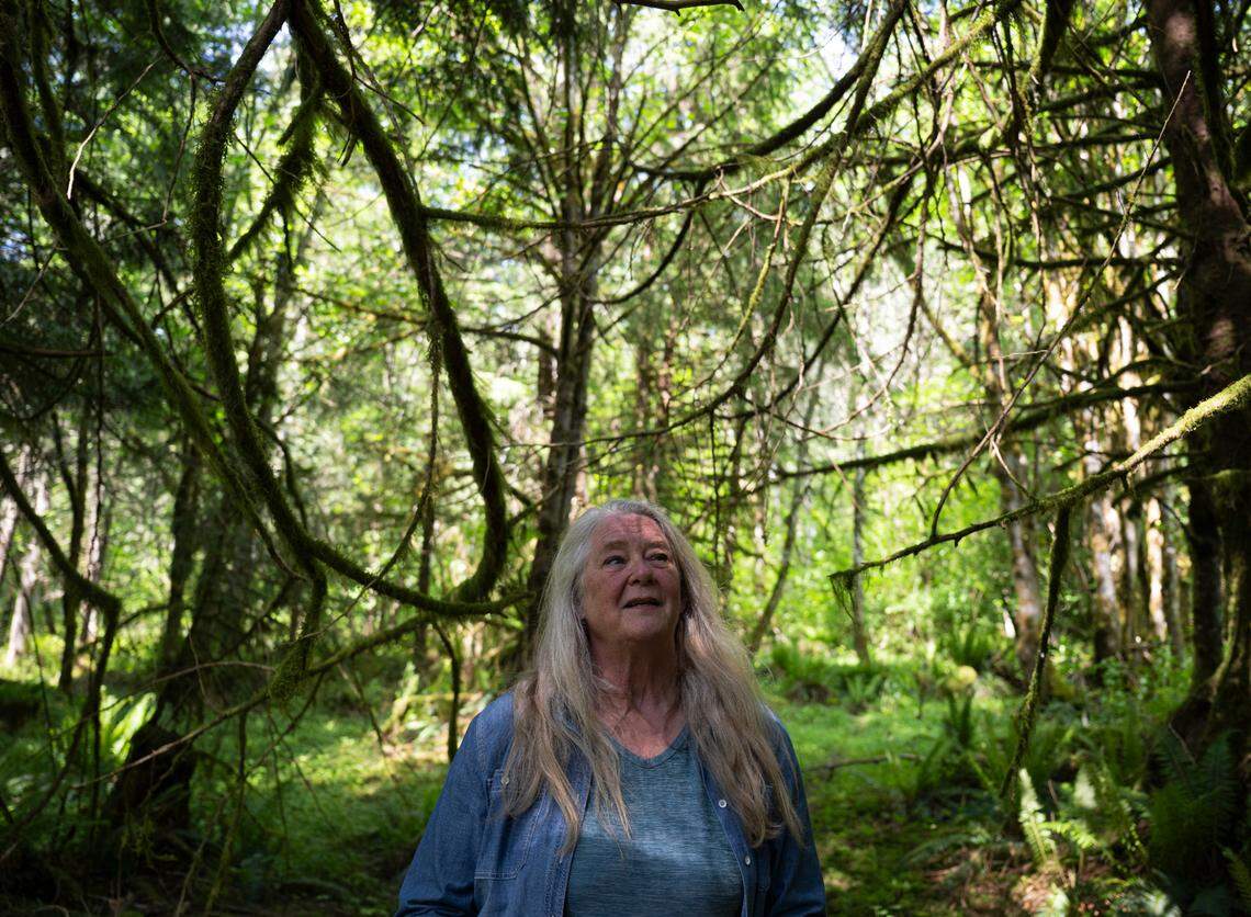 Jill Cartwright, who lives on the far side of the now-closed Fairfax Bridge and must take rough forestry roads to reach town, walks the property, on Monday, June 2, 2025, in Carbonado, Wash.