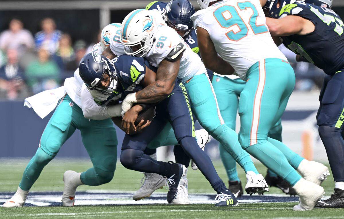 Seattle Seahawks quarterback Geno Smith (7) is sacker by Miami Dolphins linebacker Mohamed Kamara (50) during the first quarter of the game at Lumen Field, on Sunday, Sept. 22, 2024, in Seattle, Wash.