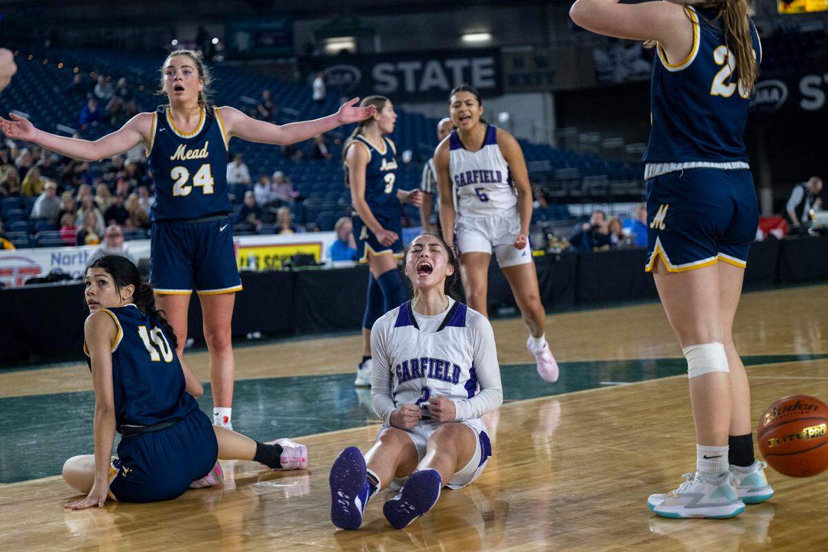 Garfield guard Katie Fiso (2) celebrates after making a basket while being fouled as Mead players look on in disbelief during the third quarter of a Class 3A semifinal game on Friday, March 3, 2023, in Tacoma, Wash.