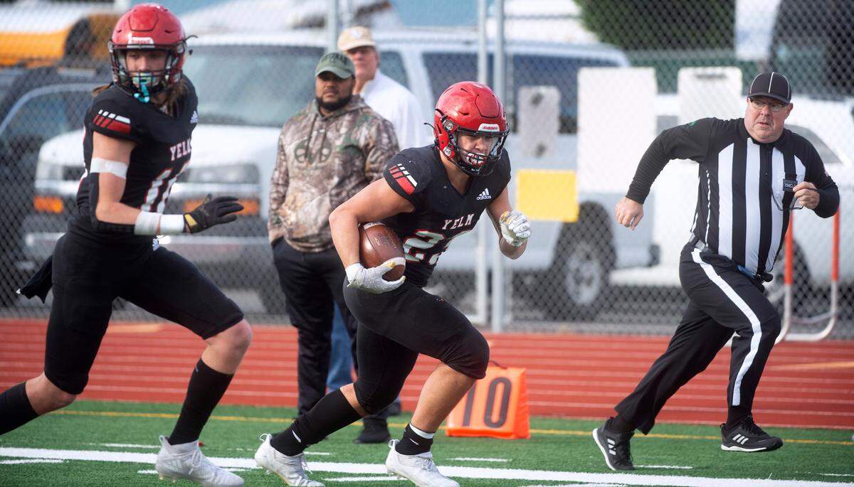 Yelm running back Brayden Platt is escored to the end zone by teammate Nathaniel Paul for a touchdown run during Saturday afternoon’s 3A football state quarterfinal game against the Marysville-Pilchuck Tomahawks at Yelm High School in Yelm, Washington, on Nov. 20, 2021. Marysville-Pilchuck won the game, 39-21.