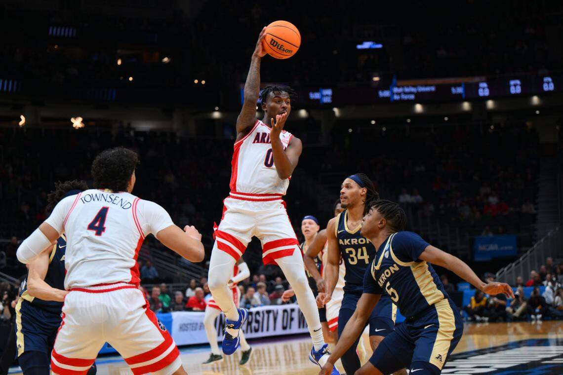 Mar 21, 2025; Seattle, WA, USA; Arizona Wildcats guard Jaden Bradley (0) makes a pass against the Akron Zips during the first half in the first round of the NCAA Tournament at Climate Pledge Arena. Mandatory Credit: Steven Bisig-Imagn Images