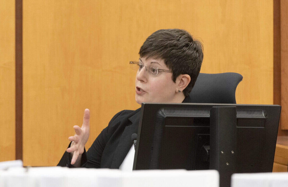 Prosecuting attorney Kent Liu (not in photo) asks questions of DNA senior analyst Teresa Cheromcha during the trial of Tacoma Police officers accused in the death of Manny Ellis held at Pierce County Superior Court, Wednesday Nov. 8, 2023, in Tacoma, Wash. Officers Christopher Burbank, Matthew Collins and Timothy Rankine are charged with his death. Presiding judge is Pierce County Superior Court Judge Bryan Chushcoff. (Ellen M. Banner / Pool / The Seattle Times)