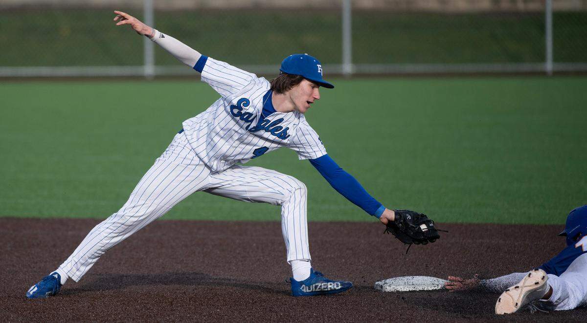 Federal Way shortstop Jay O’Neill stretches in an attempt to tag out Tahoma base runner Griffin Bye on a successful steal during Tuesday afternoon’s baseball game at Federal Way High School in Federal Way, Washington, on Tuesday, April 18, 2023. Tahoma rallied to win the game, 4-2.