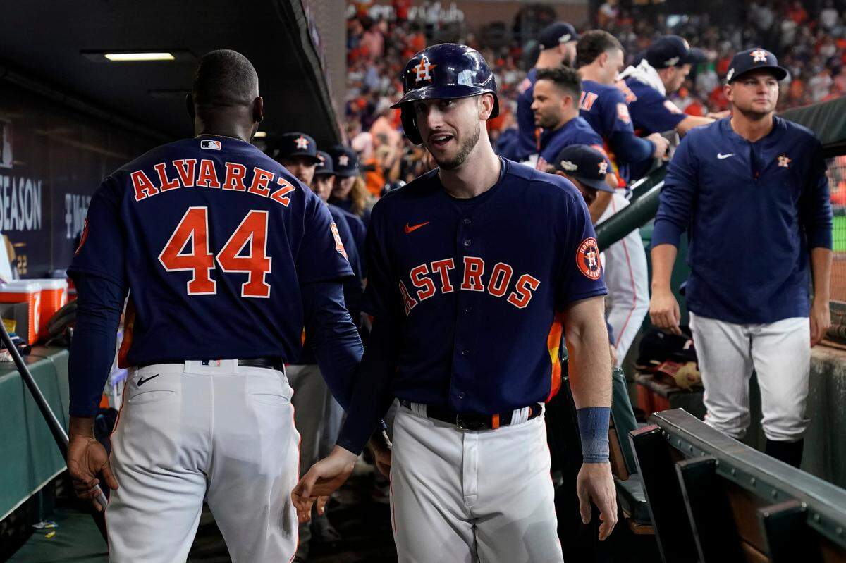 Houston Astros right fielder Kyle Tucker, center, celebrates his solo home run against the Seattle Mariners during the first inning in Game 2 of an American League Division Series baseball game in Houston, Thursday, Oct. 13, 2022. (AP Photo/David J. Phillip)