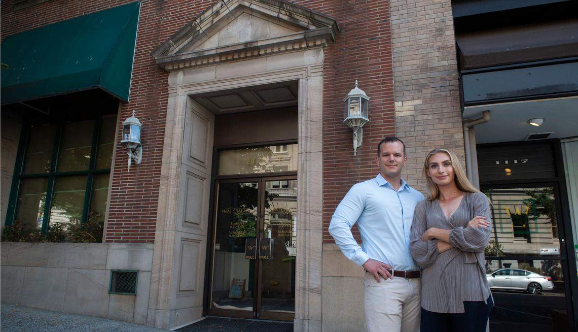 Glen and Maxine McCallum opened their specialty spirits store, McCallum & Sons Whisky Co., in December 2021. They are pictured outside the building at 1115 A St. in downtown Tacoma, Washington, in July.