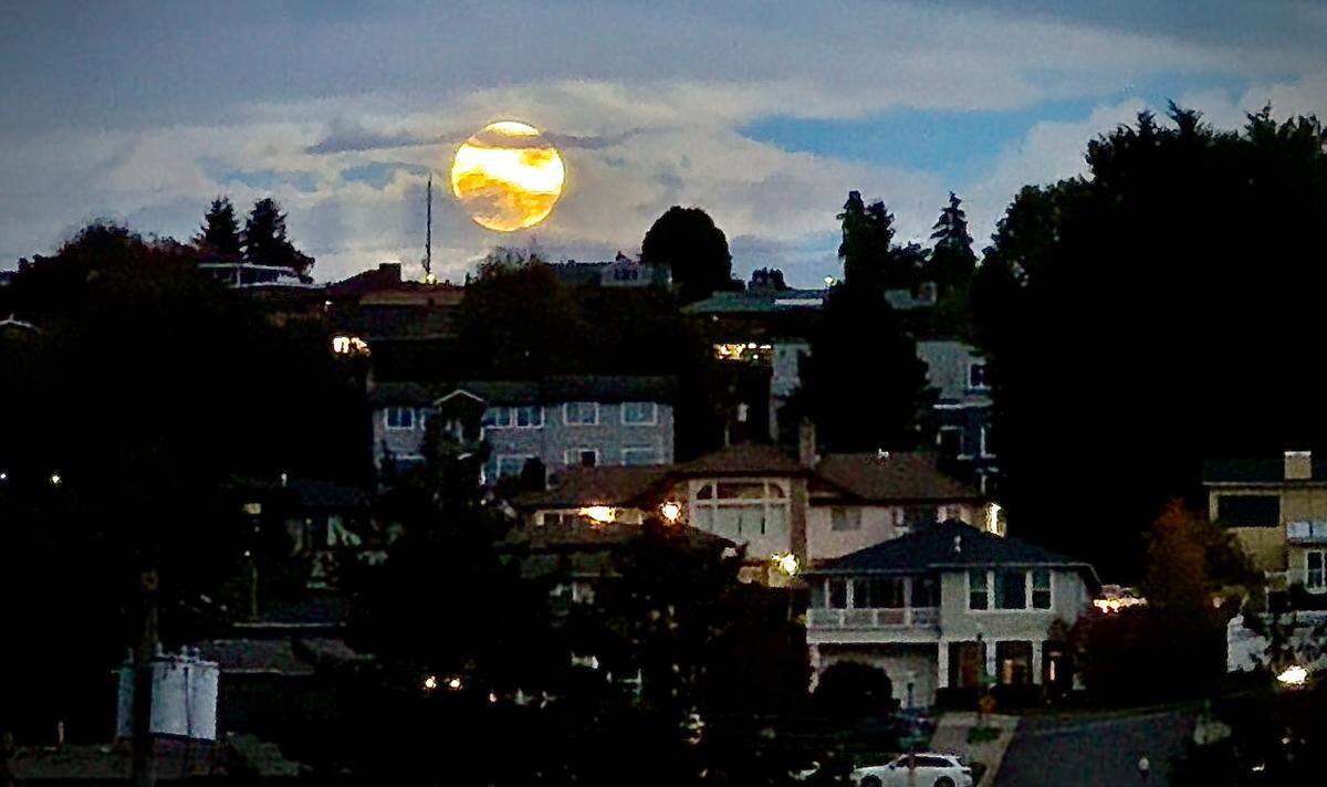 A nearly full moon rises above the Titlow Beach community on Wednesday, Oct. 16, 2024.