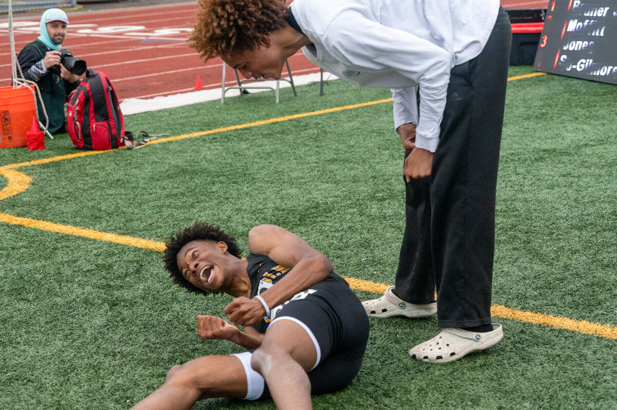 Lincoln’s Eddie Bruner Jr., left, drops to the ground in reaction to his winning time in the 3A 400-meter dash on Saturday, May 31, 2025, during the 2025 WIAA Track & Field Championships at Mount Tahoma High School in Tacoma, Wash.