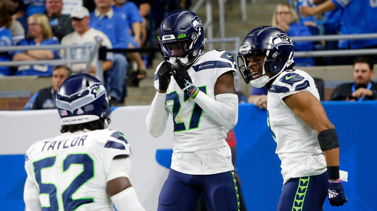 Seattle Seahawks cornerback Tariq Woolen celebrates his interception return for a touchdown during the second half of an NFL football game against the Detroit Lions, Sunday, Oct. 2, 2022, in Detroit. (AP Photo/Duane Burleson)