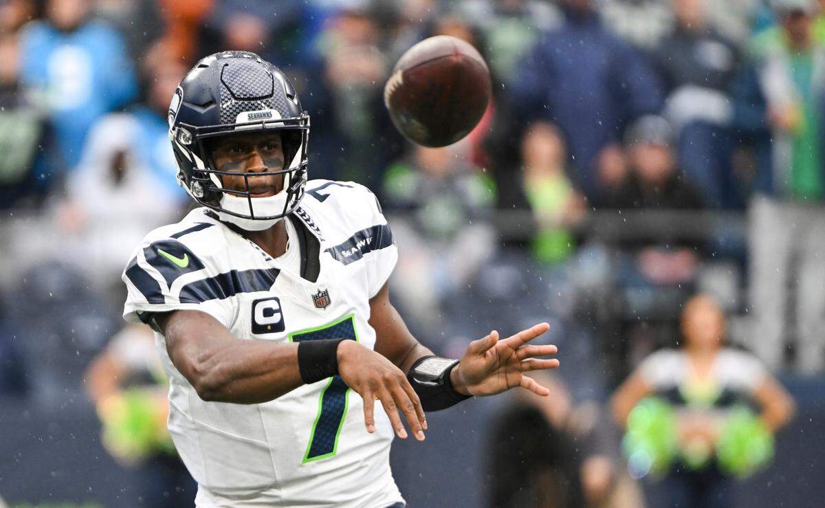 Seattle Seahawks quarterback Geno Smith (7) sidearms a pass running back Kenneth Walker III (9) during the fourth quarter against the Carolina Panthers of the game at Lumen Field, Sunday, Sept. 24, 2023, Seattle, Wash.