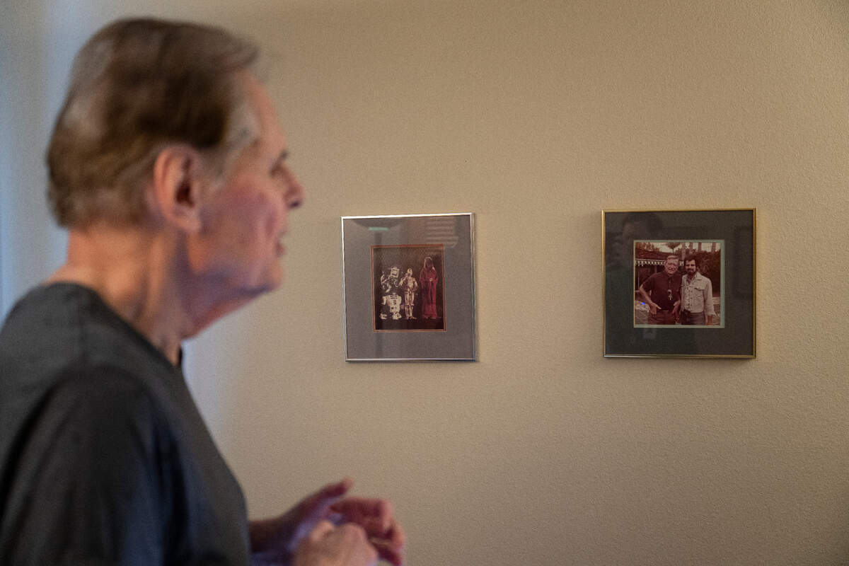 Wayne Orr looks at photos of him and John Wayne and reminisce about his time as a camera operator in Hollywood, at home, on Monday, April 8, 2024, in Lakewood, Wash.