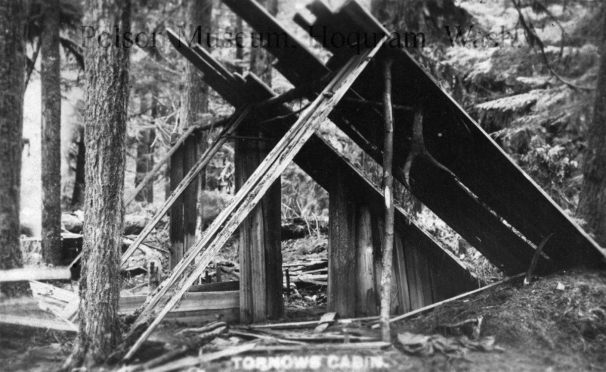 A postcard captioned, “Tornows Cabin” shows the makeshift lean-to in which he was purported to live while he was a fugitive. The “cabin” is nothing more than salvaged boards propped up against splits of wood and standing trees.