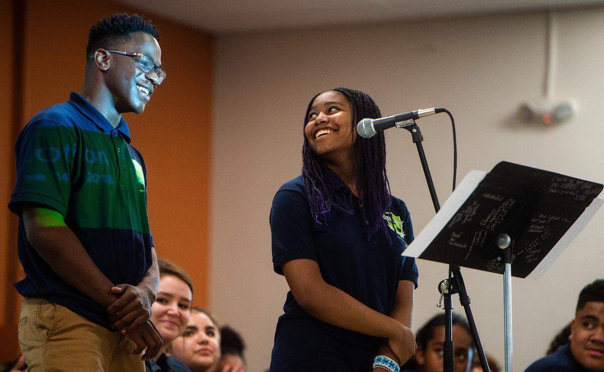 Student speakers Justin Drayton, left, and Lavina Polk, right, laugh as they share their experiences at Destiny Charter Middle School during a graduation ceremony in Tacoma on June 14, 2018.