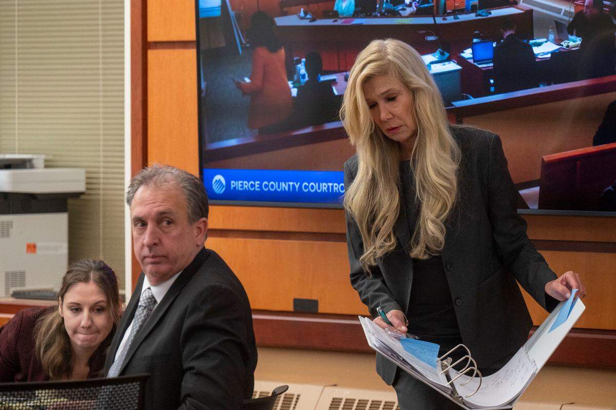 Pierce County Sheriff Ed Troyer looks over his shoulder as his attorney Anne Bremner returns to her seat after cross-examining Leah Heiberg, a South Sound 911 dispatcher, on Monday, Dec. 5, 2022, in Pierce County District Court in Tacoma.