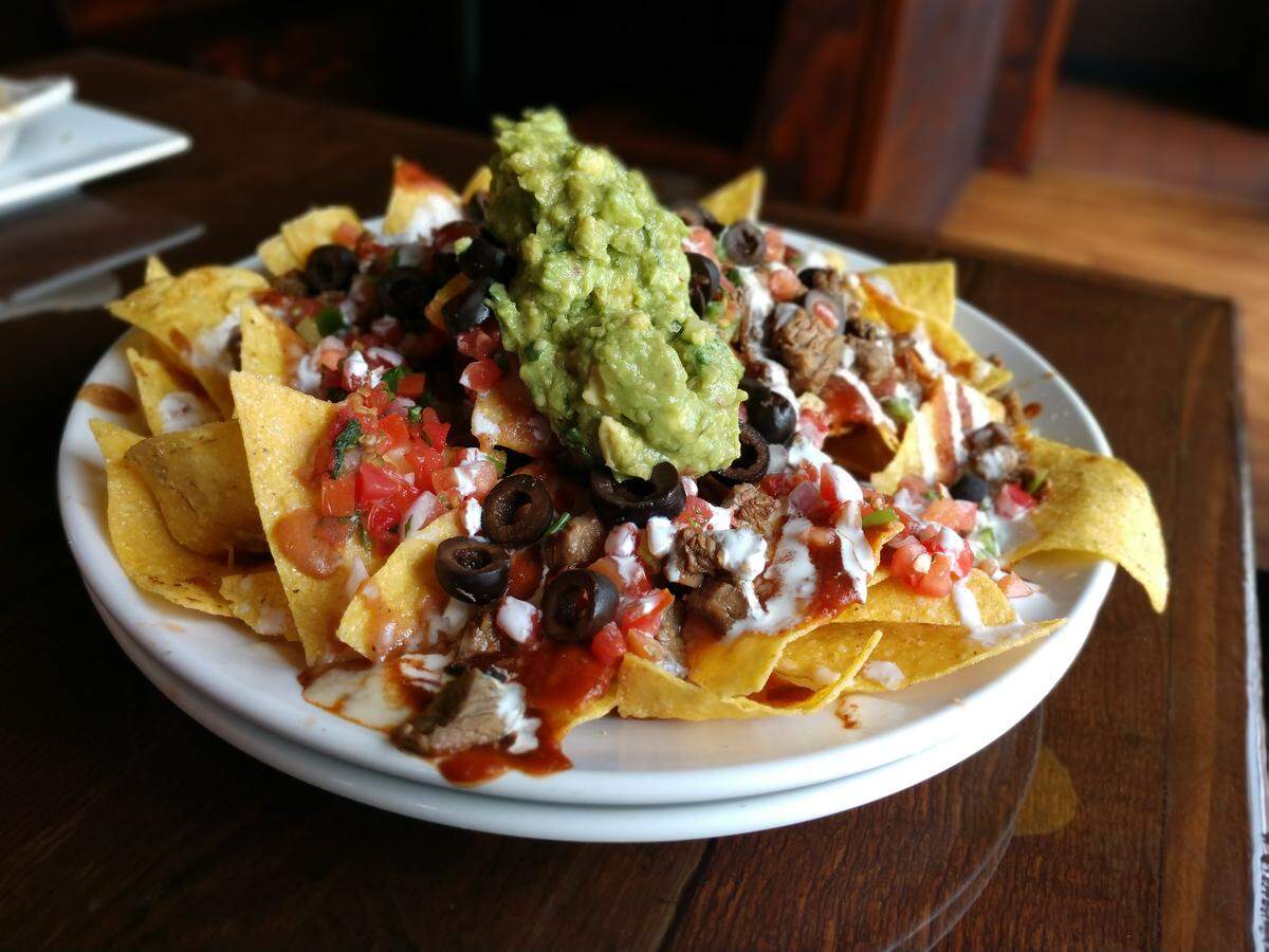 Nachos are stacked with layered ingredients at Red Star Taco Bar in Tacoma.