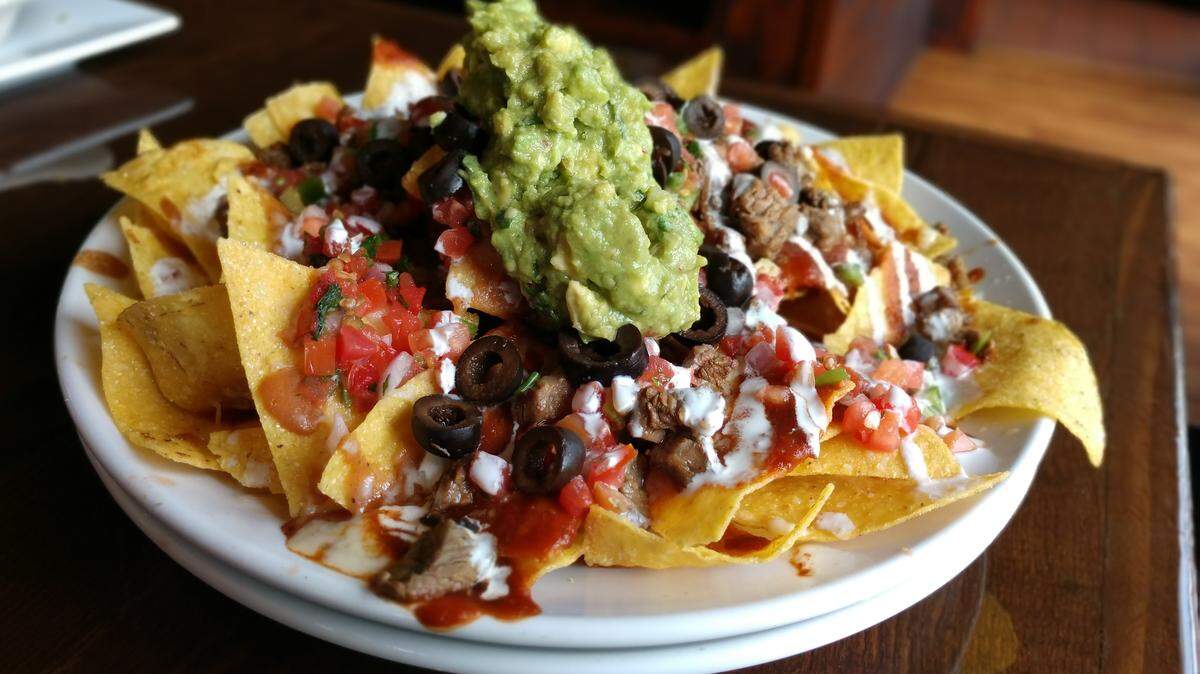 Nachos are stacked with layered ingredients at Red Star Taco Bar in Tacoma.