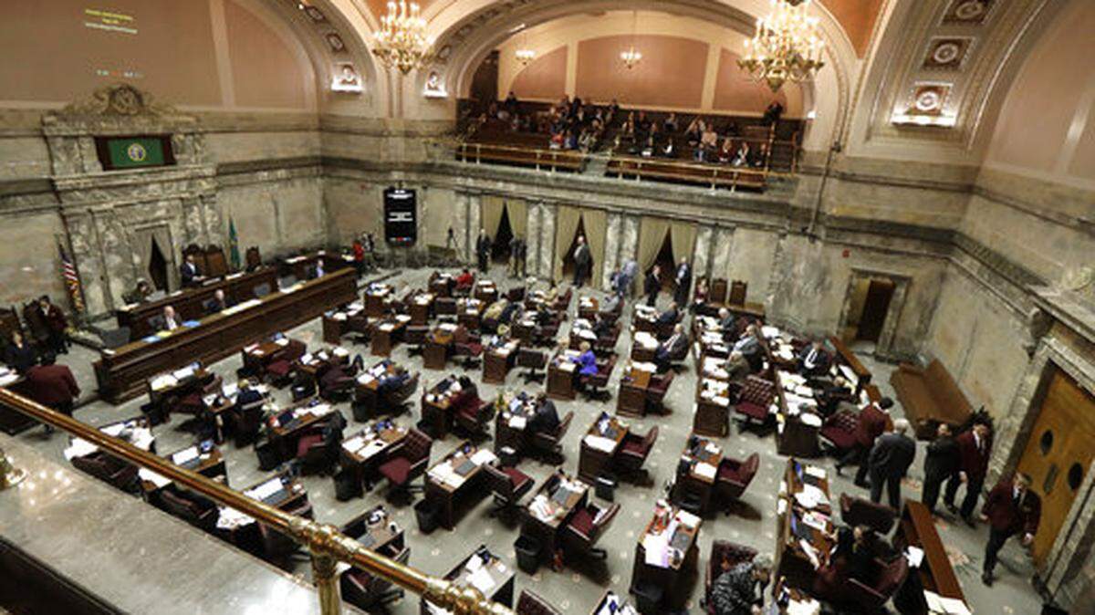 Lawmakers work on the Senate floor at the Capitol in Olympia.