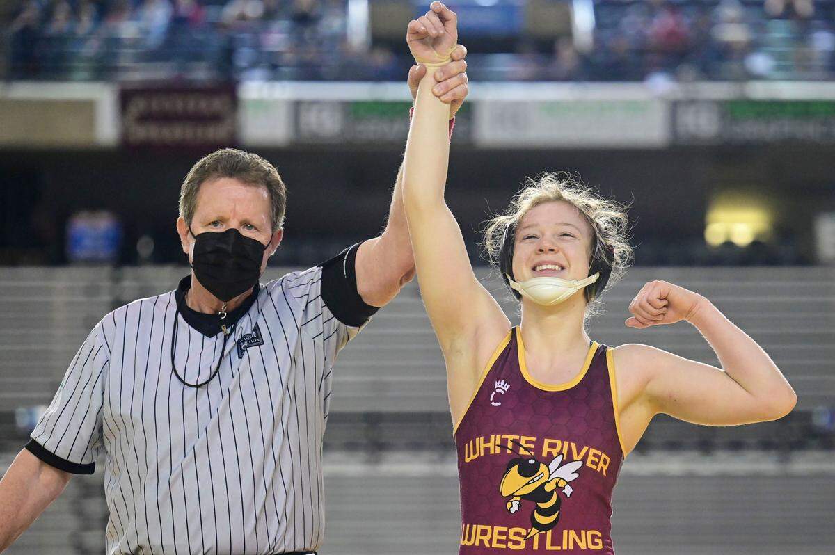 White River’s Shelby Moore celebrates after pinning Marysville Pilchuck’s Juju Kilroy in the 130-pound girls championship match at Mat Classic XXXIII on Saturday, Feb. 19, 2022, at the Tacoma Dome in Tacoma, Wash. Moore, finished the season undefeated at 27-0.
