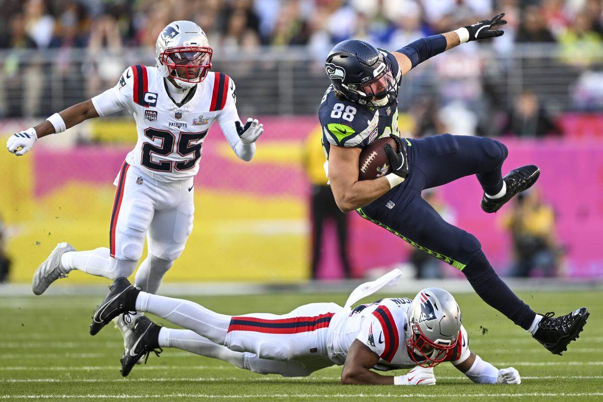 Seattle Seahawks tight end AJ Barner (88) is tackled by New England Patriots safety Craig Woodson (31) in the first quarter of Super Bowl LX at Levi's Stadium on Feb. 8, 2026 in Santa Clara, Calif.