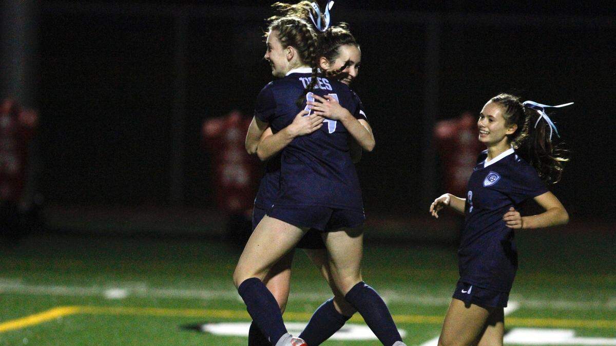 Gig Harbor’s Alyssa Gray celebrates with teammates Anna Stewart, middle and Tatum Griffin, right, after scoring her second goal in Gig Harbor’s 3-1 win in the opening round of the Class 3A state tournament against West Seattle on Tuesday, Oct. 6, 2018.