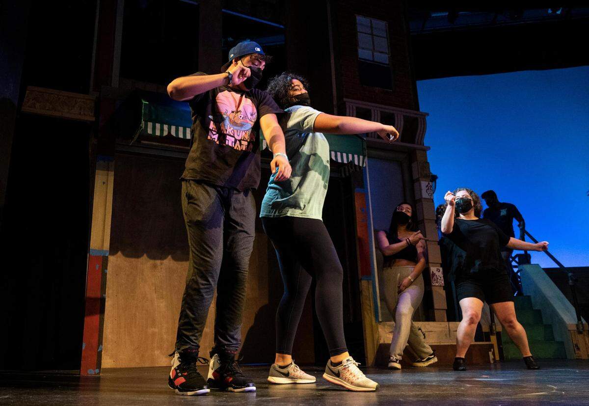 Nick Marston, 17, a junior at Silas High School, left, and Jordan Talley, 15, a sophomore at Fife High School, center, rehearse their roles for “In the Heights” at the Tacoma Musical Playhouse in Tacoma, Wash. on Thursday, May 5, 2022. Marston and Talley also performed at the Apollo Theatre in New York for the Next Narrative competition’s finals after winning the semi-finals in Seattle.