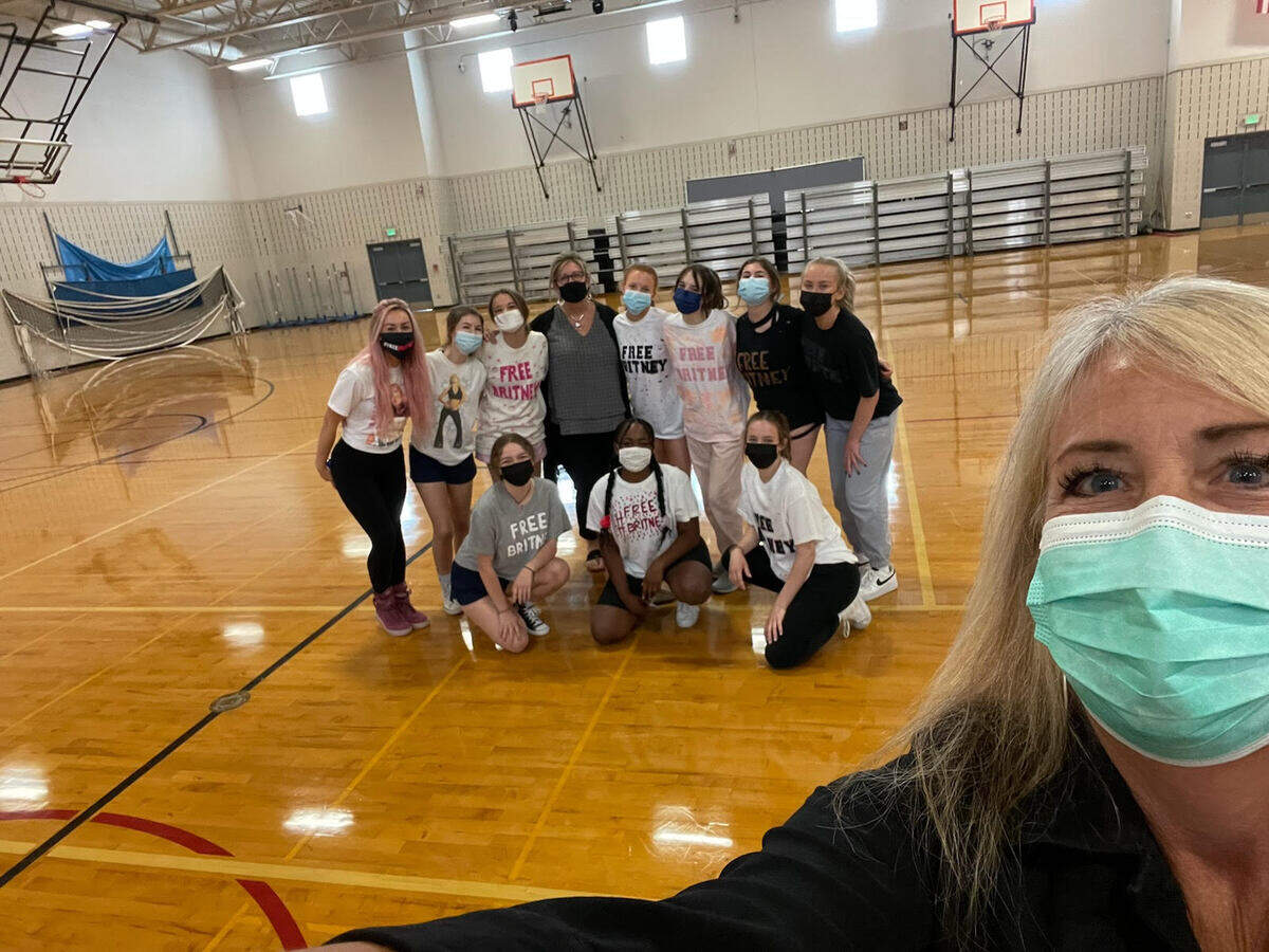 Peninsula School District Superintendent Krestin Bahr takes a photo with the Gig Harbor High School dance team and the school principal during one of the team’s first practices in 2021.