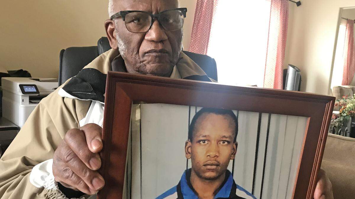 Eliud Ibirthi holds a photo of his son, Kelvin, a 34-year-old homeless man who died in the snow during the recent storm. Originally from Kenya, the men arrived in the United States as political asylum seekers about 15 years ago.