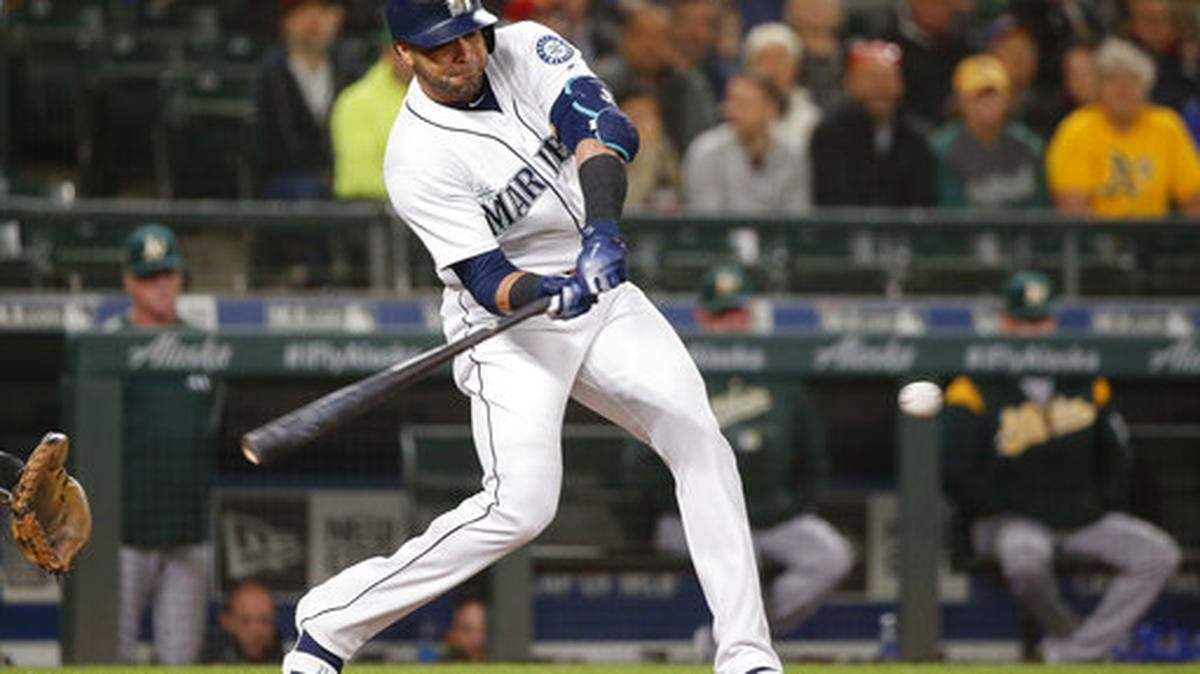 Seattle Mariners’ Nelson Cruz hits a three-run home run off Oakland Athletics starting pitcher Brett Anderson during the first inning of a baseball game Tuesday, Sept. 25, 2018, in Seattle. (AP Photo/Jennifer Buchanan)