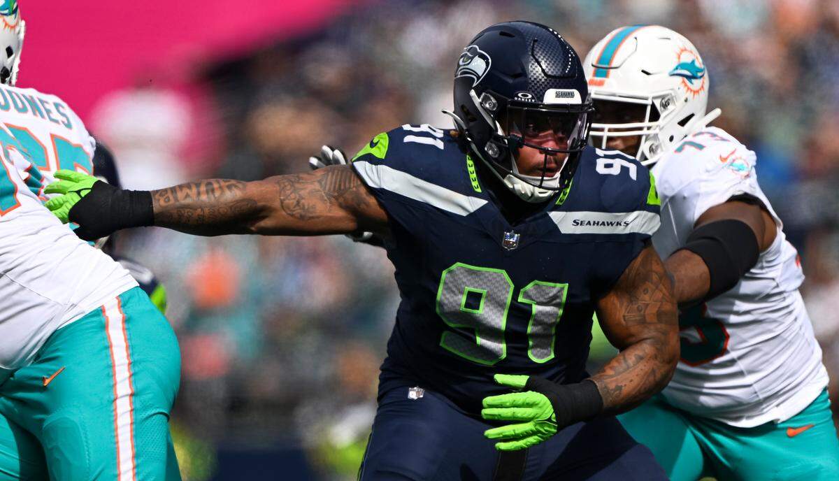 Seattle Seahawks defensive tackle Byron Murphy II (91) eyes the ball in the interior during the first quarter of the game against the Miami Dolphins at Lumen Field, on Sunday, Sept. 22, 2024, in Seattle, Wash.