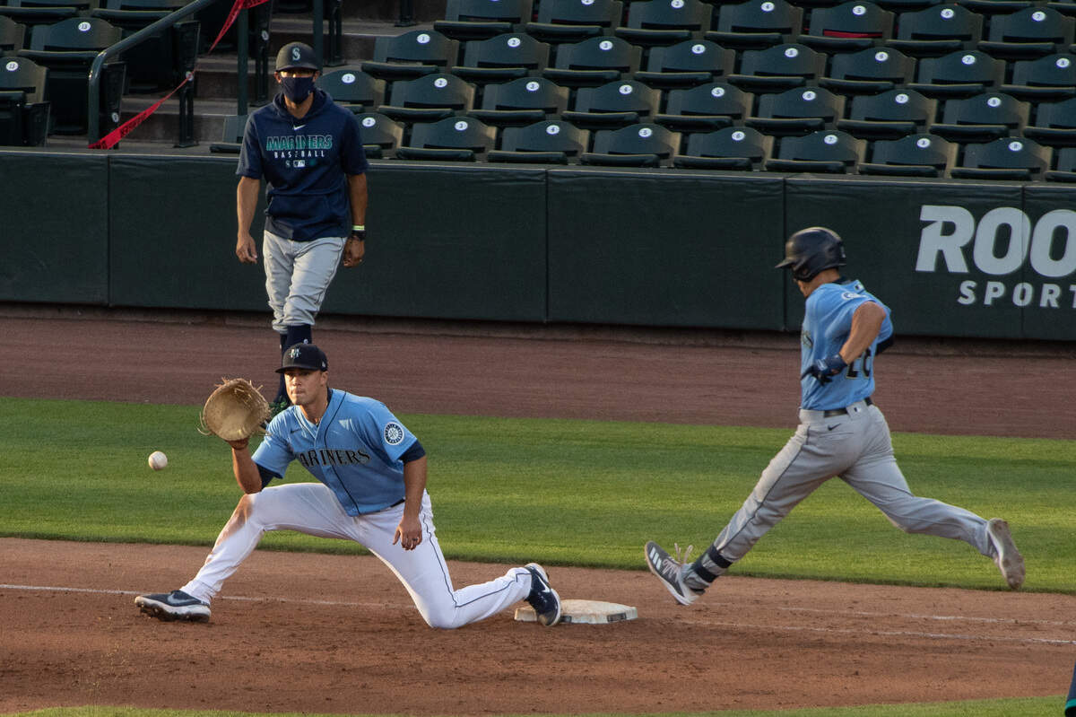 Seattle Mariners first baseman Evan White (12) makes a play at first for an out during the Seattle Mariners intrasquad game at T-Mobile Park in Seattle, Wash., on Saturday, July 18, 2020.