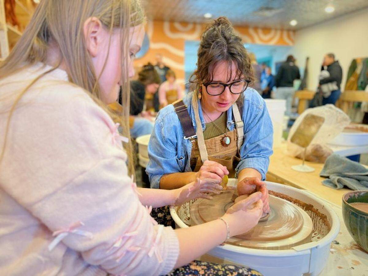 Potters use the wheel at The Bisque, a new pottery studio in Port Orchard, Wash., at the studio’s grand opening Saturday, Jan. 24, 2026.