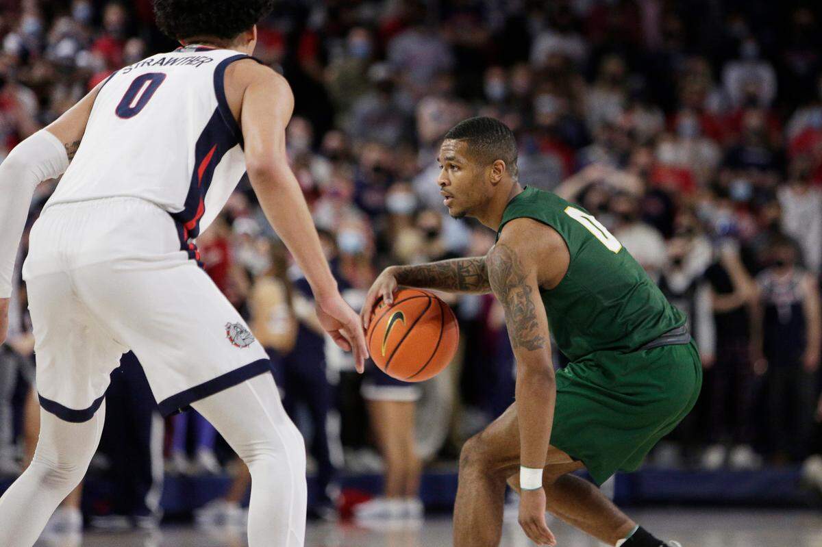 San Francisco guard Khalil Shabazz, right, controls the ball while defended by Gonzaga guard Julian Strawther during the second half of an NCAA college basketball game, Thursday, Jan. 20, 2022, in Spokane, Wash. (AP Photo/Young Kwak)
