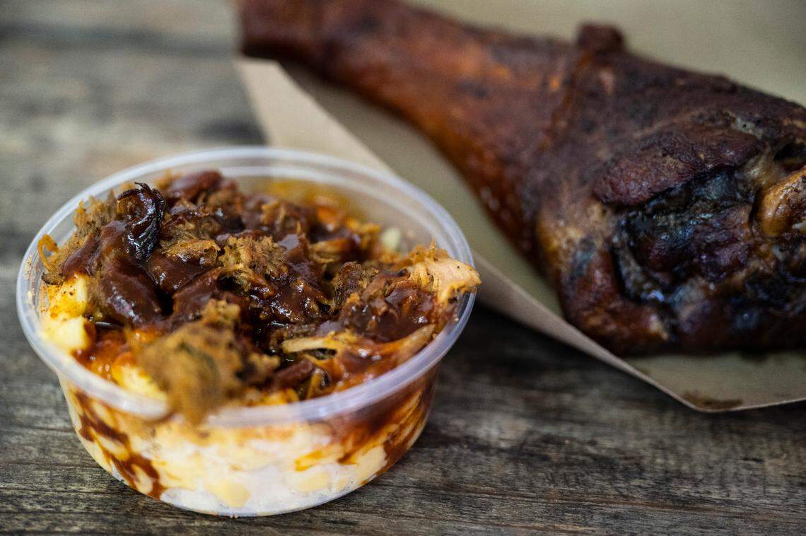 A cup of brisket mac and cheese, substituted with pulled pork, and a smoked turkey leg from Brank’s BBQ.
