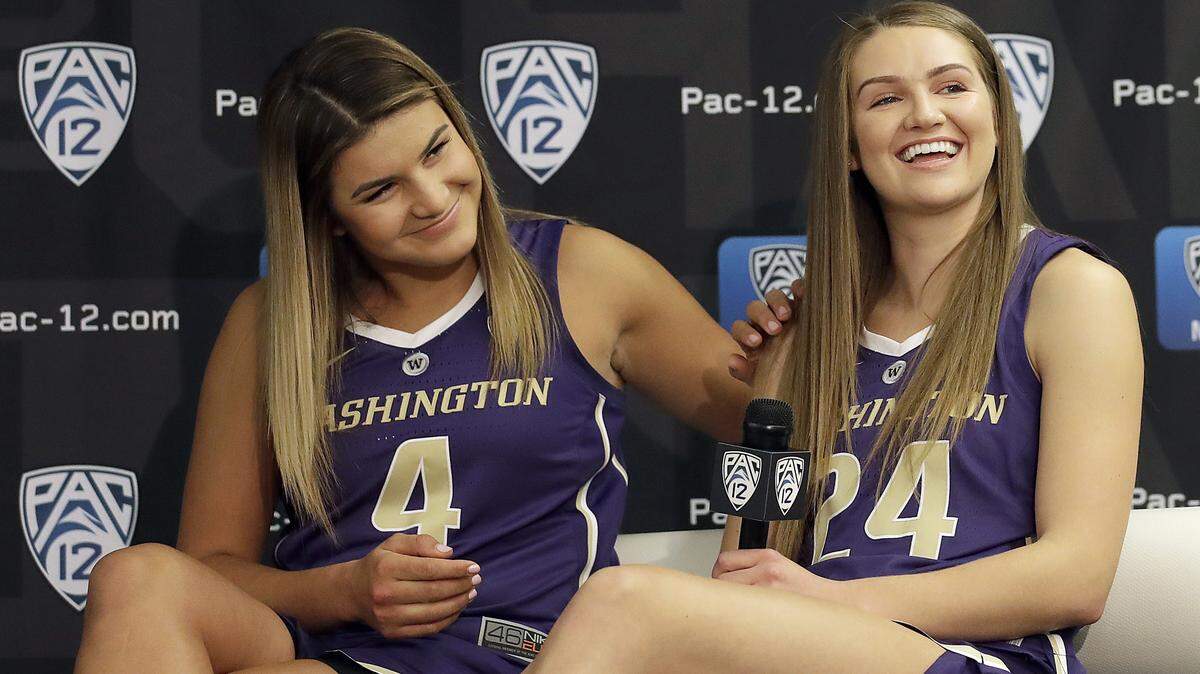 Washington’s Amber Melgoza, left, and Jenna Moser listen to questions during NCAA college basketball Pac-12 media day in San Francisco, Wednesday, Oct. 10, 2018. (AP Photo/Jeff Chiu)