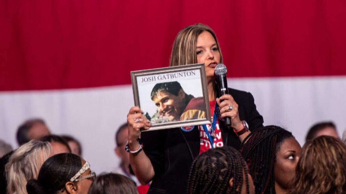 Kimberley Gatbunton gives a presentation on gun violence while holding a picture of her son, Joshua. He died from a gunshot wound to the head more than 12 years ago at a friend’s apartment in Tacoma. He was 20 years old.