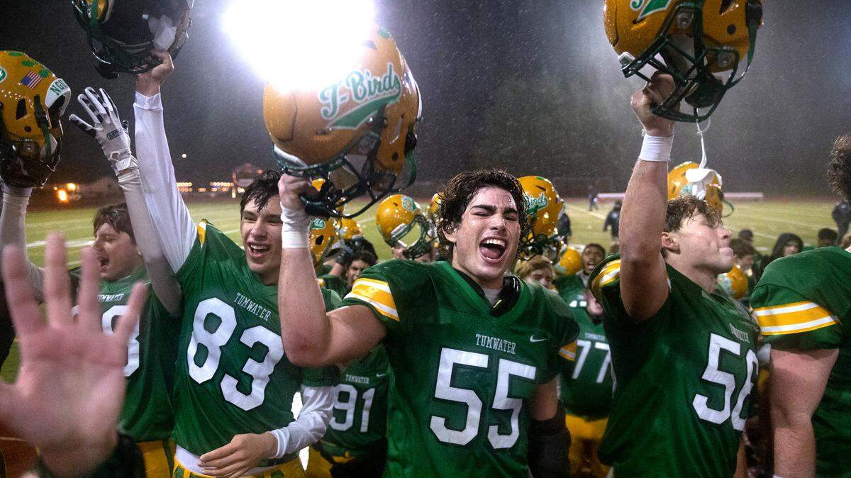 Tumwater’s Zack Schmidt (83), Caleb Sadlemyer (55) and Bennett Ferris celebrate following the T-Birds 14-2 victory over the Squalicum Storm in Saturday’s 2A football state semifinal at Tumwater District Stadium in Tumwater, Washington, on Nov. 27, 2021.