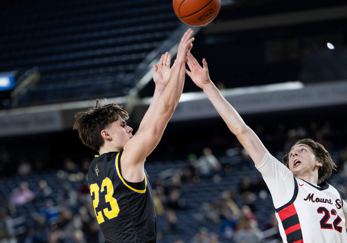 Puyallup’s Drew Jones (23) shoots over Mount Si’s Chase Mentink (22) during the first half of a Class 4A state basketball tournament quarterfinal game at the Tacoma Dome on Thursday, March 6, 2025, in Tacoma, Wash.