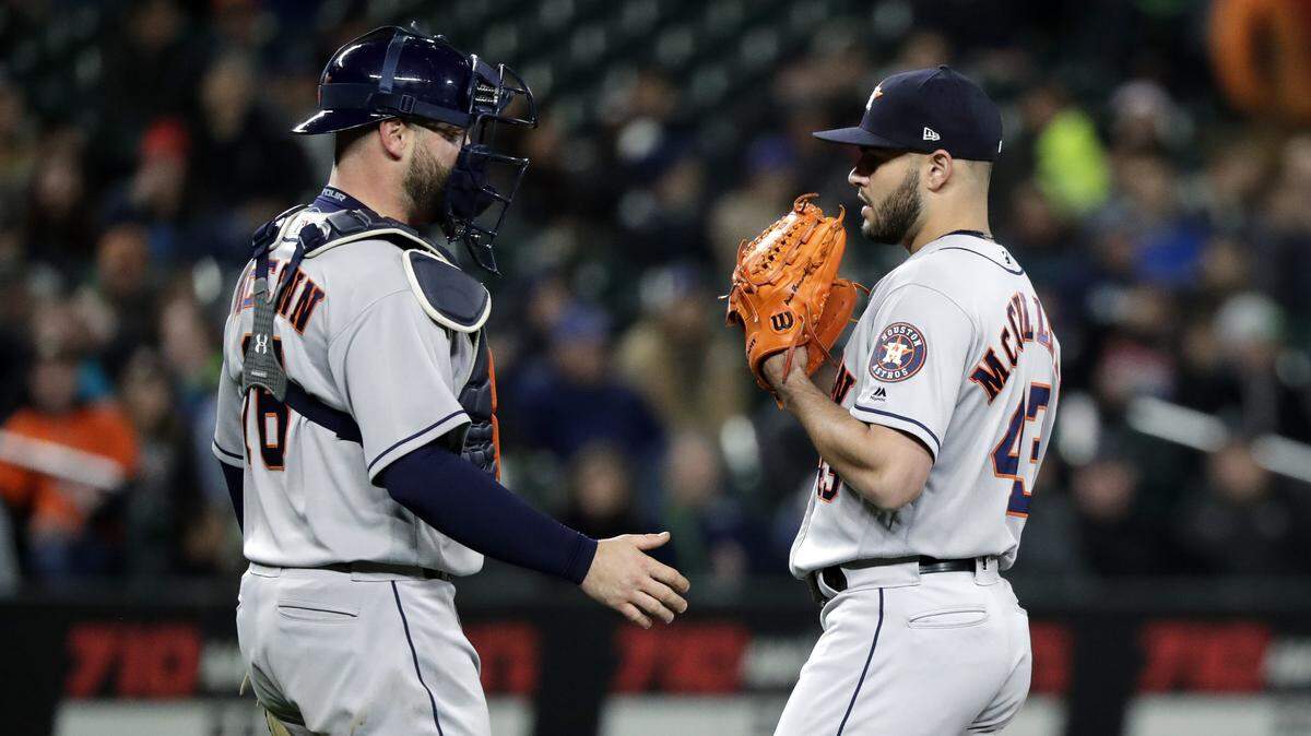 Houston Astros starting pitcher Lance McCullers Jr., right, chats with catcher Brian McCann during a baseball game against the Seattle Mariners Tuesday, April 17, 2018, in Seattle. (AP Photo/Elaine Thompson)