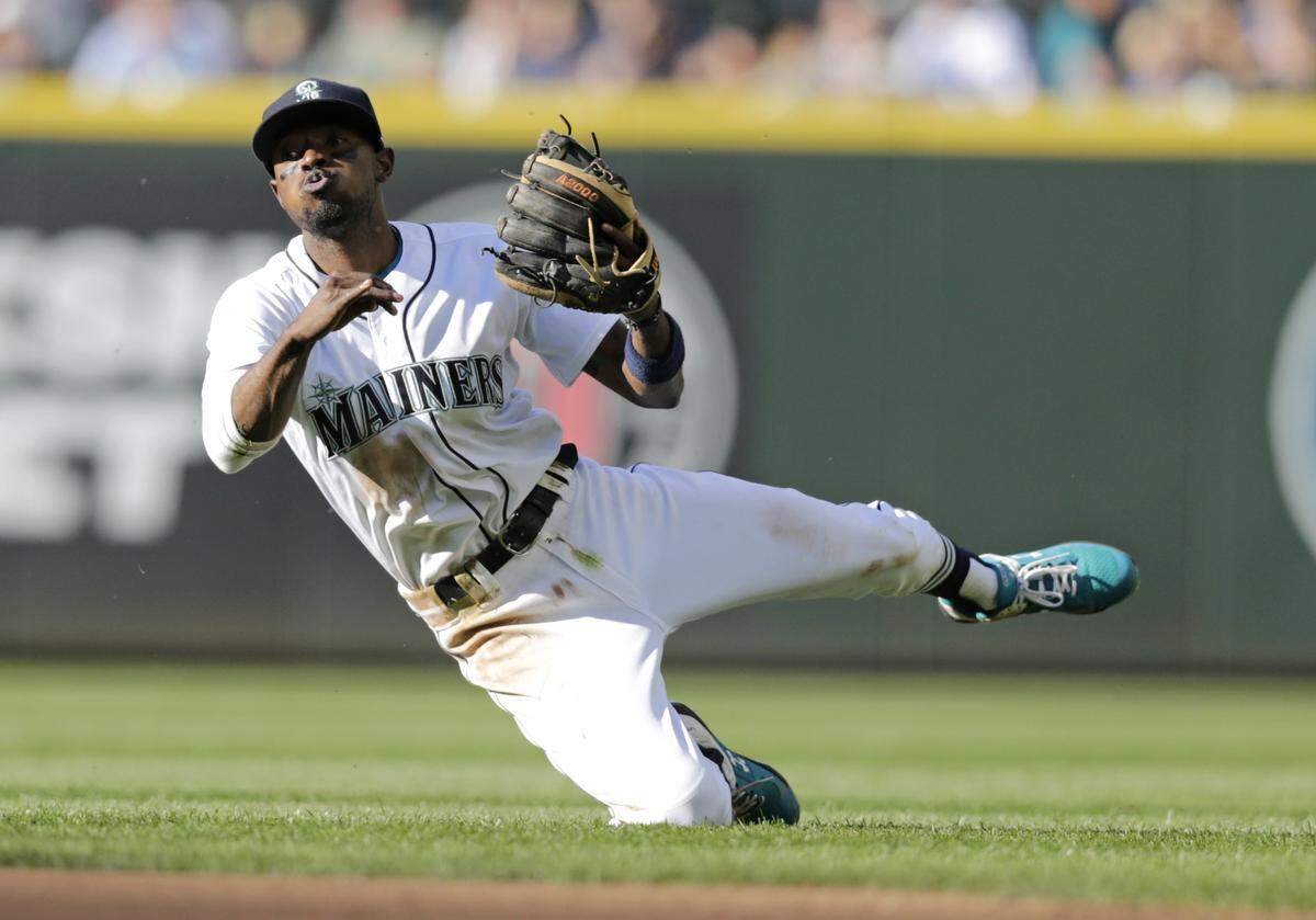 Seattle Mariners second baseman Dee Gordon throws to first from his knee to catch Boston Red Sox’s Xander Bogaerts out during the fifth inning of a baseball game Saturday, June 16, 2018, in Seattle. (AP Photo/John Froschauer)