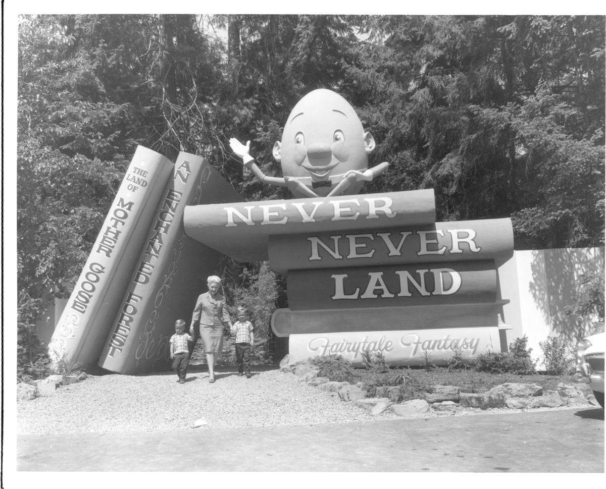 William Trueblood Collection Series: TPL-1926 (Unique: 19735) Date: 06-02-1965 Description: An unidentified family exits Never Never Land at Point Defiance in June 1965. The popular park attraction first opened in 1964. Alfred Pettersen, who also designed “Wooded Wonderland” in Victoria, British Columbia, was the first manager. The two facilities were said to be the only two “enchanted forests” on the continent. Sadly, Tacoma’s enchanted forest has been plagued by petty vandalism over the years.