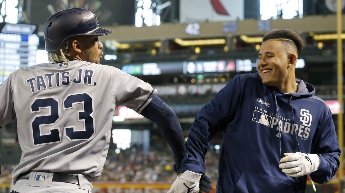 San Diego Padres Fernando Tatis Jr. (23) celebrates with Manny Machado after hitting a solo home run against the Arizona Diamondbacks in the fifth inning during a baseball game, Sunday, April 14, 2019, in Phoenix. (AP Photo/Rick Scuteri)