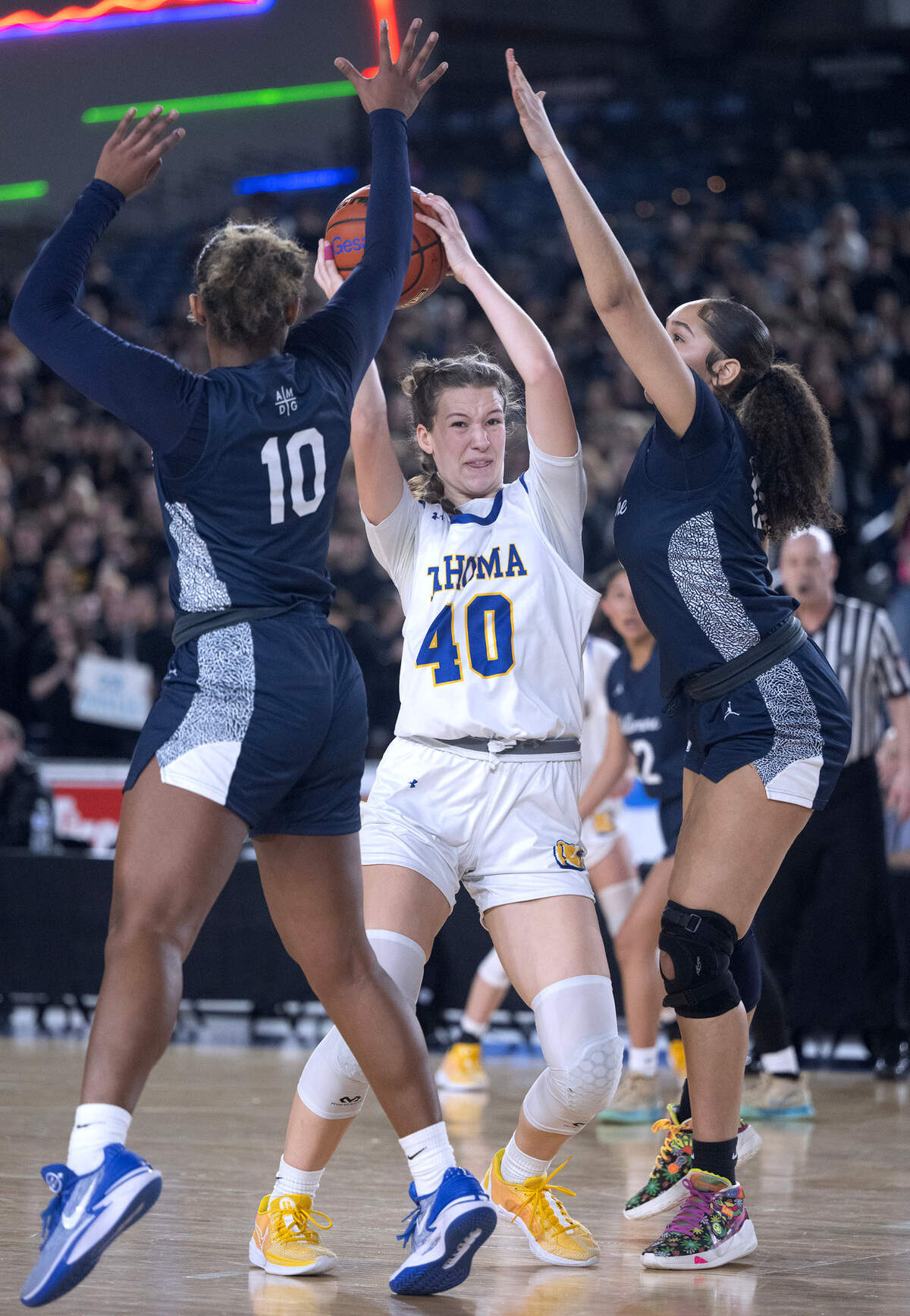 Tahoma’s Adalynn Busch is surrounded by Bellarmine defenders Kyla Frazier (10) and Stella Wiggins during Wednesday morning’s opening-round game of the 4A girls state basketball tournament in the TacomaDome in Tacoma, Washington, on Wednesday, Feb. 28, 2024. Tahoma won the game, 53-38.