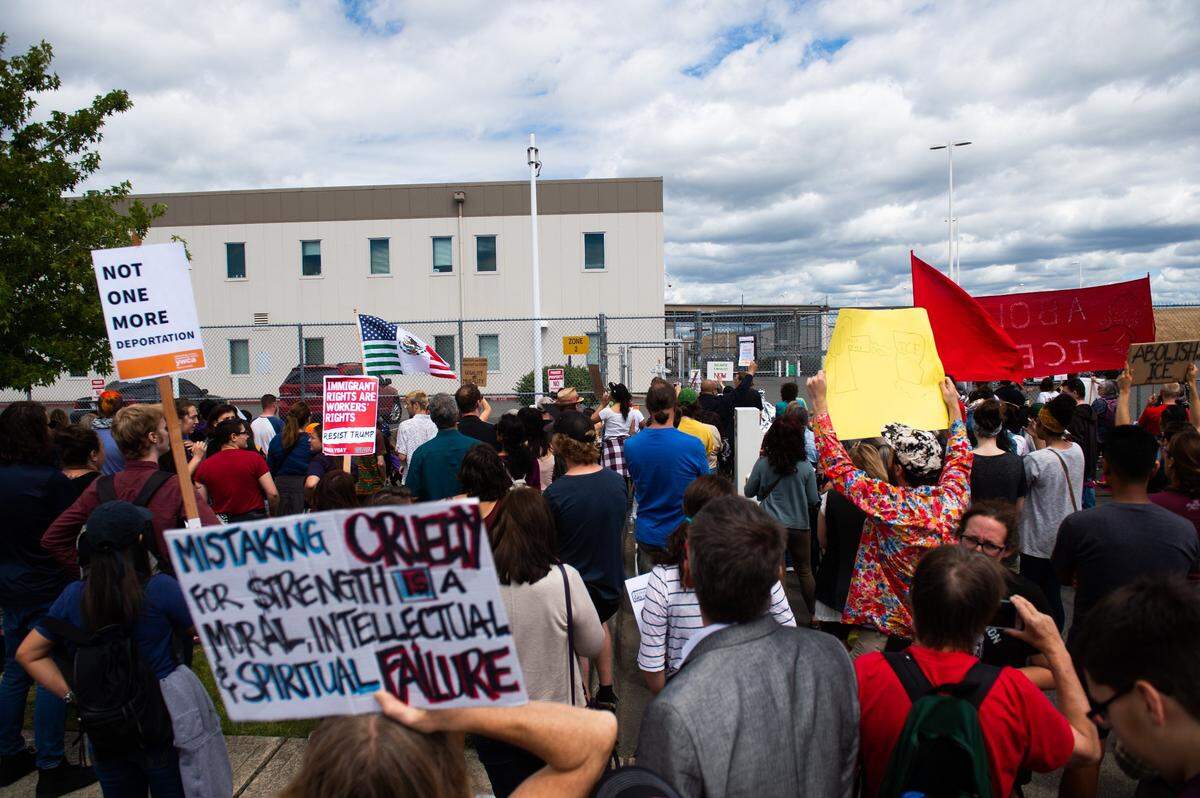 People protesting Trump’s immigration policies gathered outside the Northwest Detention Center in Tacoma, Wash., on Sunday, July 1, 2018. About 300 people showed up for the protest.