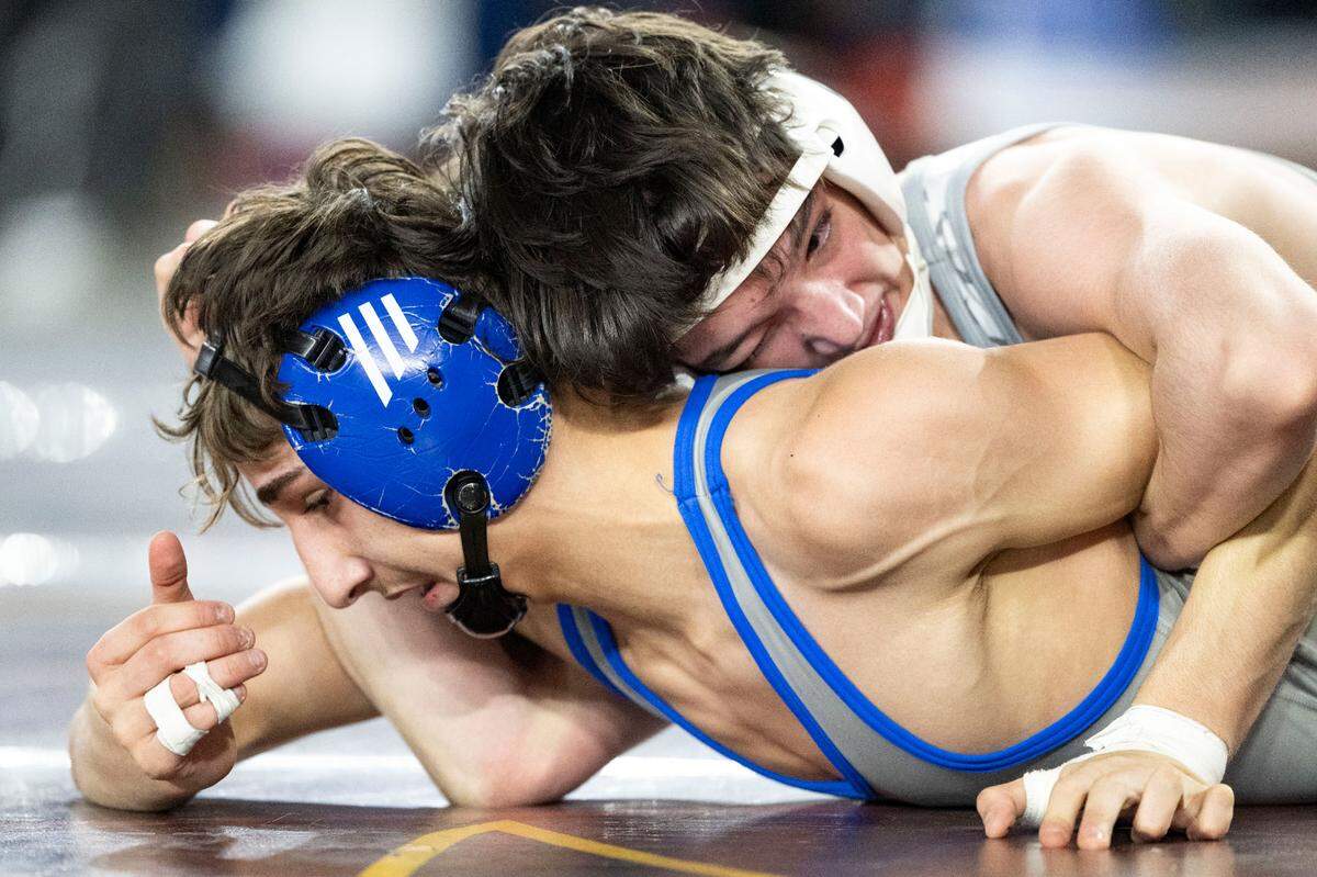 Capital’s Lazarus McEwen brings Kent Meridian’s Farzad Karimi to the mat during their Class 3A, 106-pound weight classification championship match on Friday, Feb. 21, 2025, at Mat Classic XXXVI at the Tacoma Dome in Tacoma.