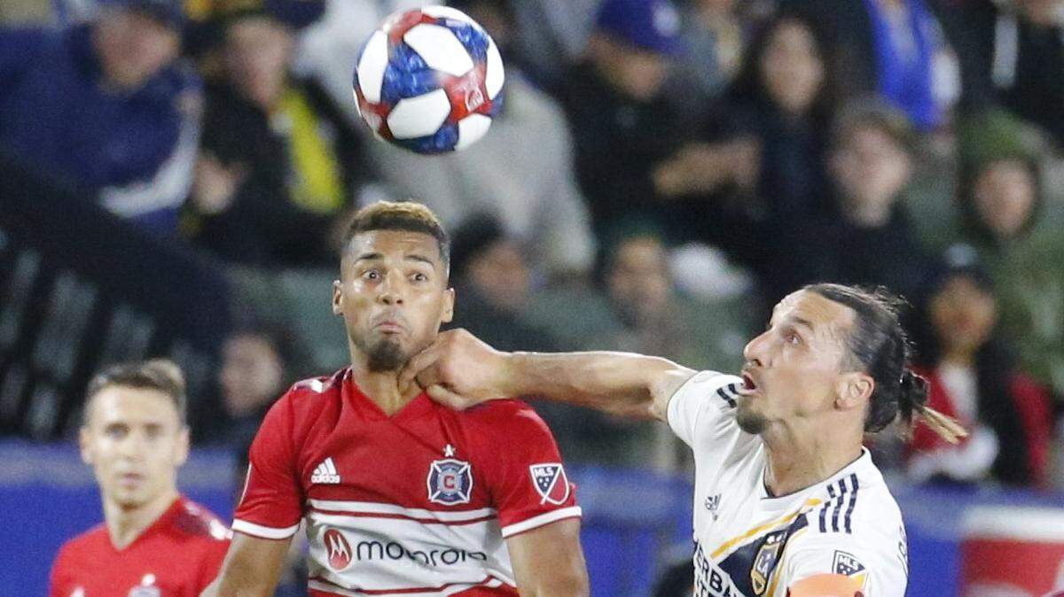 LA Galaxy forawrd Zlatan Ibrahimovic (9) of Sweden and Chicago Fire defender Johan Kappelhof (4) of Netherlands, vie for a ball during an MLS soccer match between LA Galaxy and Chicago Fire in Carson, Calif., Saturday, March 2, 2019. The Galaxy won 2-1. (AP Photo/Ringo H.W. Chiu)