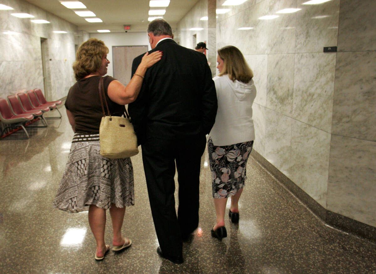 Victims’ advocate, Lew Cox, center, walks with Colleen Shapel, left, the widow of Bob Shapel, and the Shapel’s daughter Melissa Hansen, right, following a pre-trial hearing of Jeremy Hosford, who was charged with aggravated first-degree murder of the Snap-on Tools truck driver, Bob Shapel. Photographed June 27, 2006.