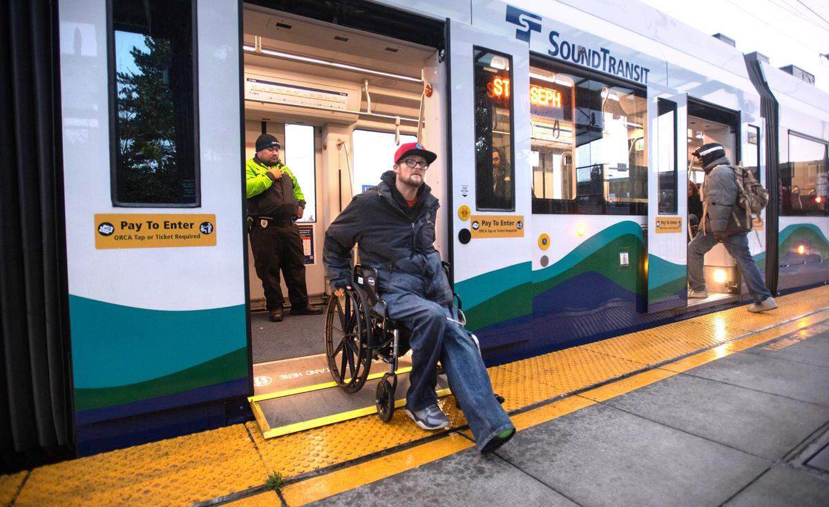 Mario Guizetti unloads from the Tacoma Light Rail train at the 25th Street Station in Tacoma, Washington, on Thursday, Nov. 9, 2023.