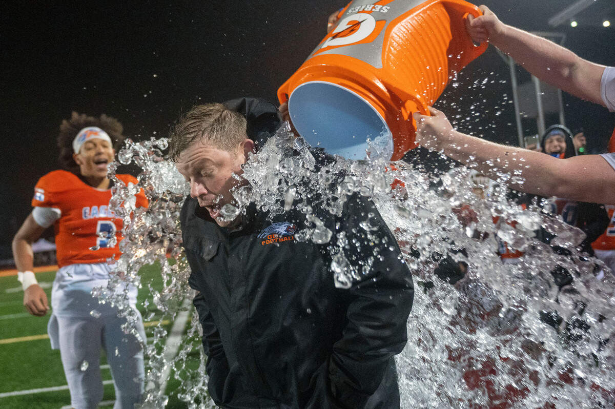 Graham Kapowsin head coach Eric Kurle is doused with water in the final minute of the fourth quarter as the Eagles begin to celebrate their 44-7 win over Lake Stevens in the State 4A championship game on Saturday afternoon at Mount Tahoma Stadium in Tacoma.